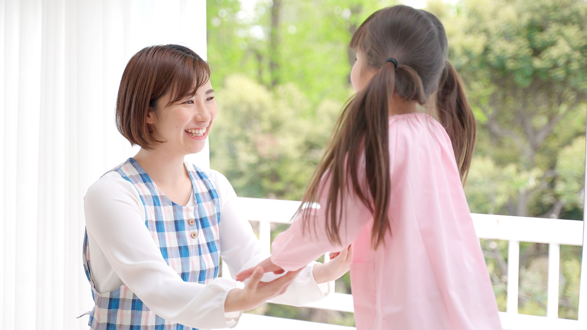 young asian girl playing with childminder